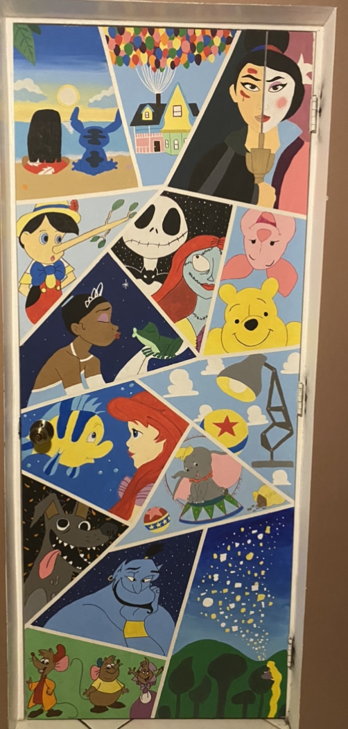 A handpainted door showcasing a collage of Disney characters throughout the years.