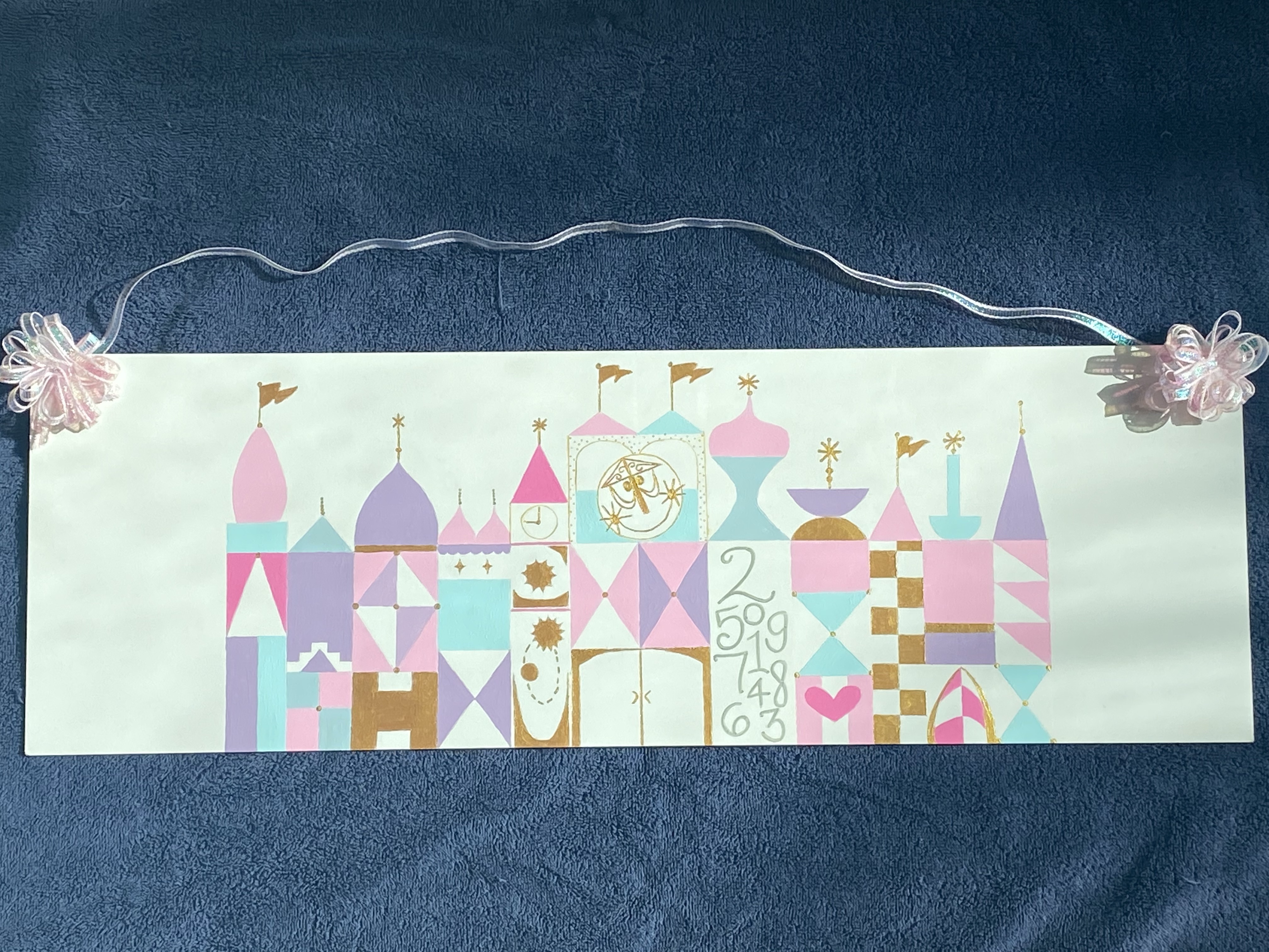 A pink, purple, blue, and gold building with geometric designs.